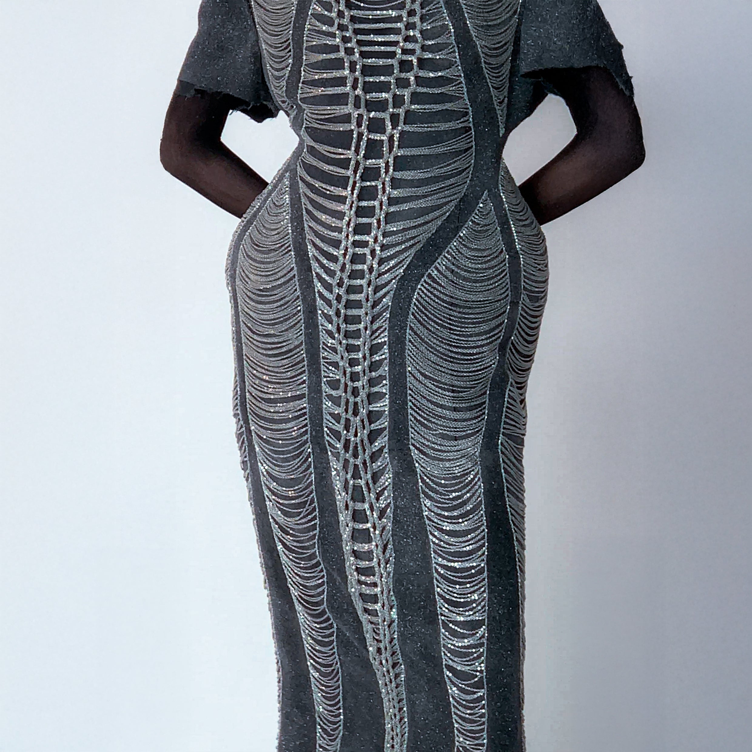 glittery gray long dress with chains details on light gray background 