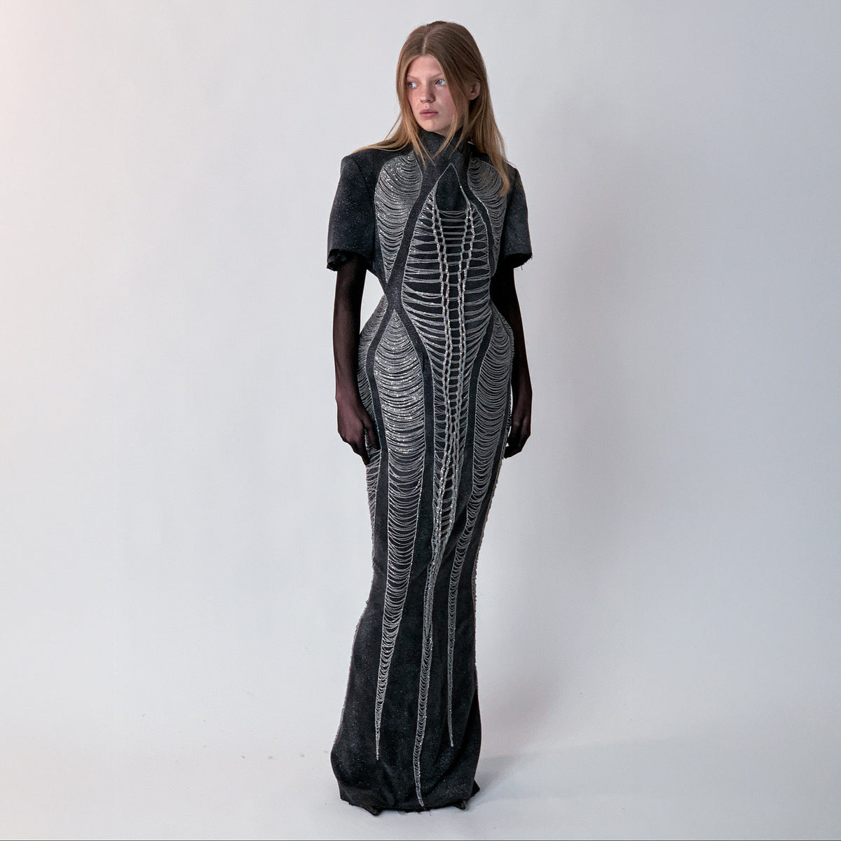 glittery gray long dress with chains details on light gray background 