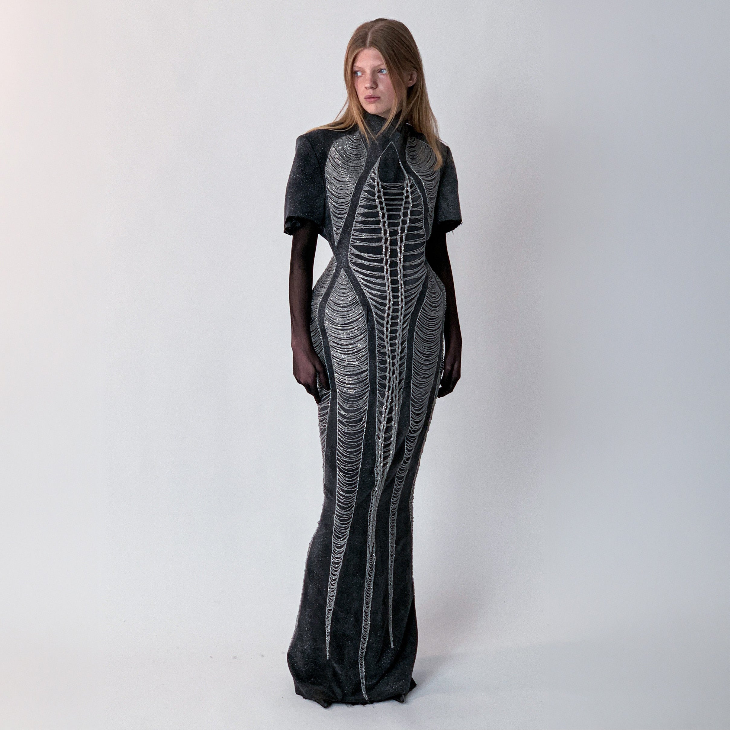 glittery gray long dress with chains details on light gray background 
